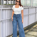 Women's Trendy Wide Leg Jeans in Dark Blue with high-waist fit, premium denim fabric, front and back pockets, and belt loops by Trendy Buzz.

