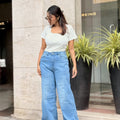 Women's Trendy Wide Leg Jeans in Light Blue with high-waist fit, front and back pockets, belt loops and relaxed wide-leg silhouette by Trendy Buzz.