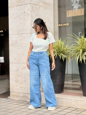 Women's Trendy Wide Leg Jeans in Light Blue with high-waist fit, front and back pockets, belt loops and relaxed wide-leg silhouette by Trendy Buzz.