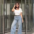 Women's Wide Leg Baggy Jeans in Mid Blue with high-waist fit, back elastic waistband, front and back pockets, belt loops, and premium denim fabric by Trendy Buzz