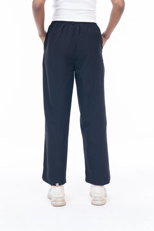 Navy blue pants worn by a person on a white background