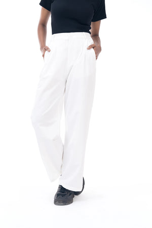 Person wearing white pants and a black top on a white background