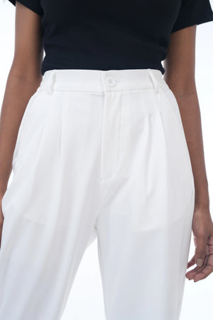 White pants worn by a person on a white background